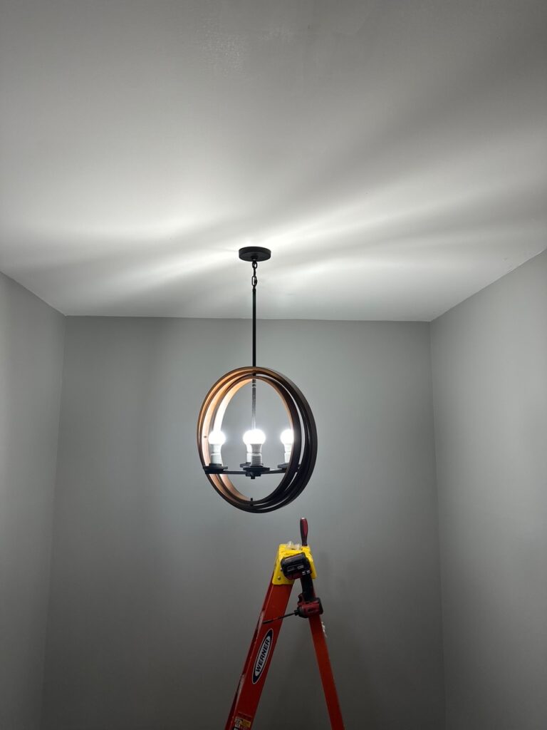 Licensed electrician upgrading lighting fixture