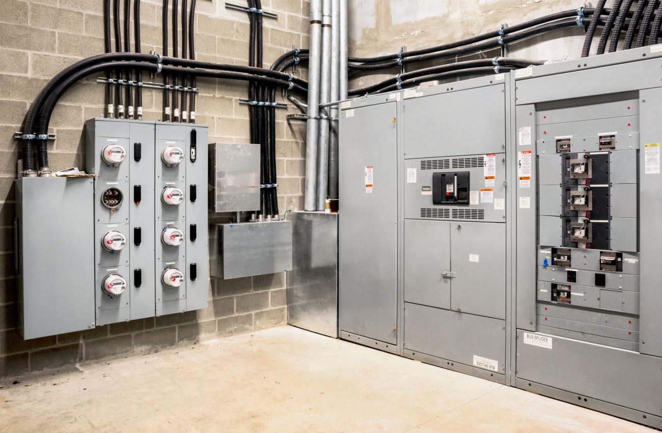 Electrical room of residential or commercial building. Multiple Hudson Electric crew arriving for commercial electrician service call